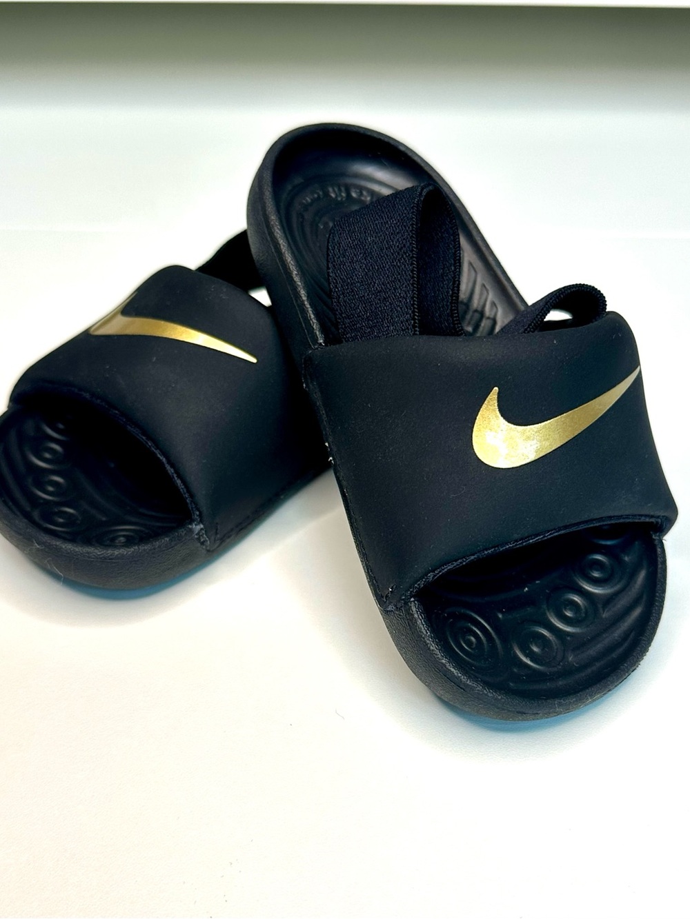 Nike Kids Black Slides with Gold Swoosh